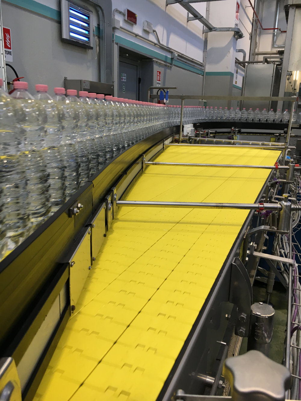 a conveyor belt with bottles of water